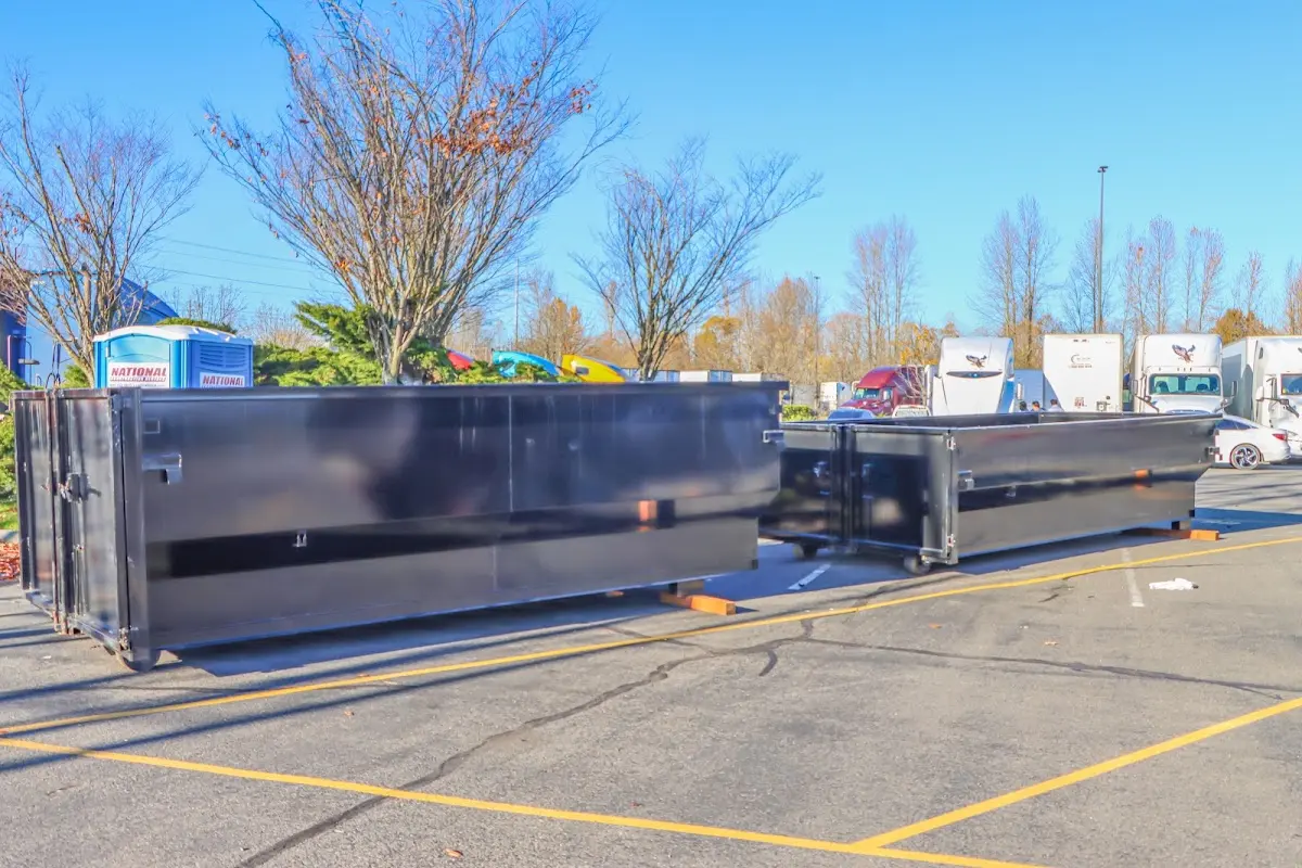 Professional dumpster rental service with roll-off container on residential driveway in West Chester